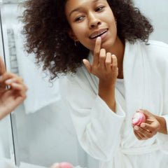 Woman applying lipbalm to her lips