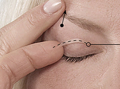 Woman applying a eyelid lifting tape on her eye 