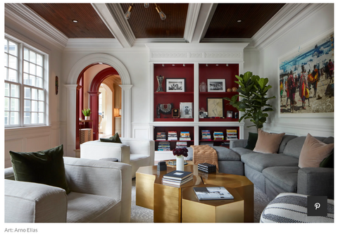 Warm and inviting living room with neutral sofa, gold coffee table, and fiddle leaf fig tree.