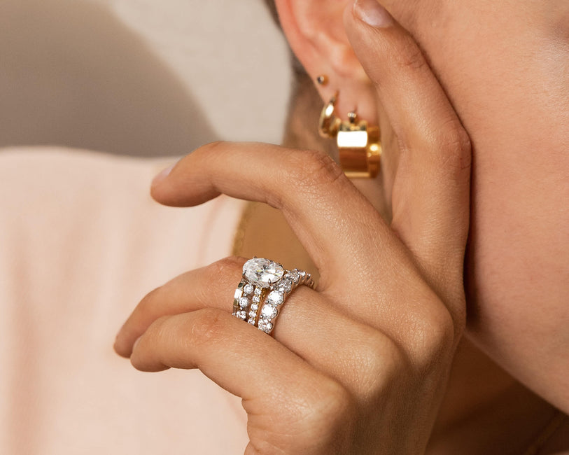 Person wearing Wedding Rings, an Engagement Ring, and Earrings