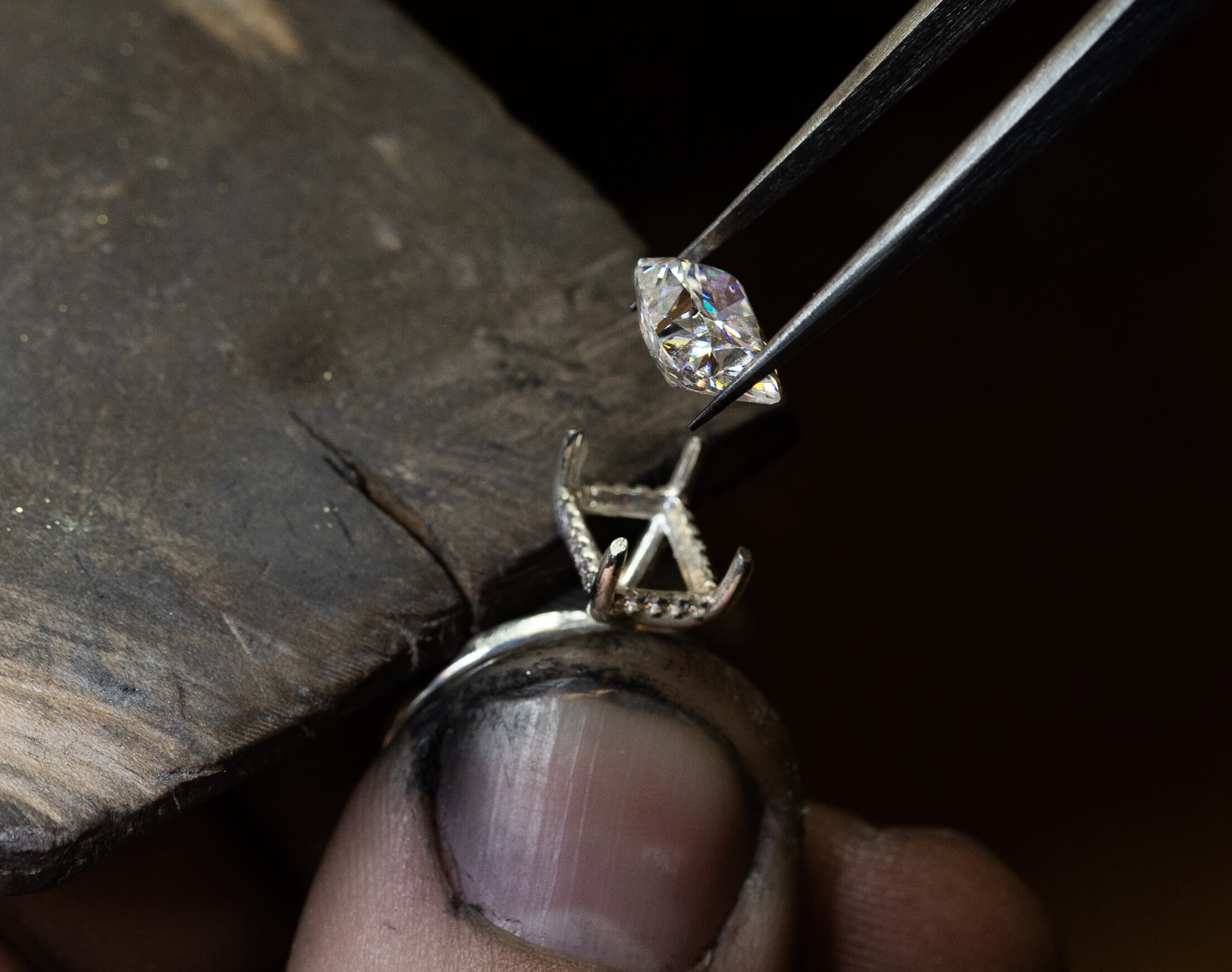 Jeweller setting a diamond in a ring