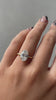 Cecilia - Oval Solitaire with Wrap Around Hidden Halo Lifestyle Image