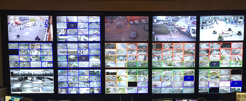 CCTV Control Panel with Wall of Monitors, by Mark Yeomans, CC BY-SA 4.0, via Wikimedia Commons