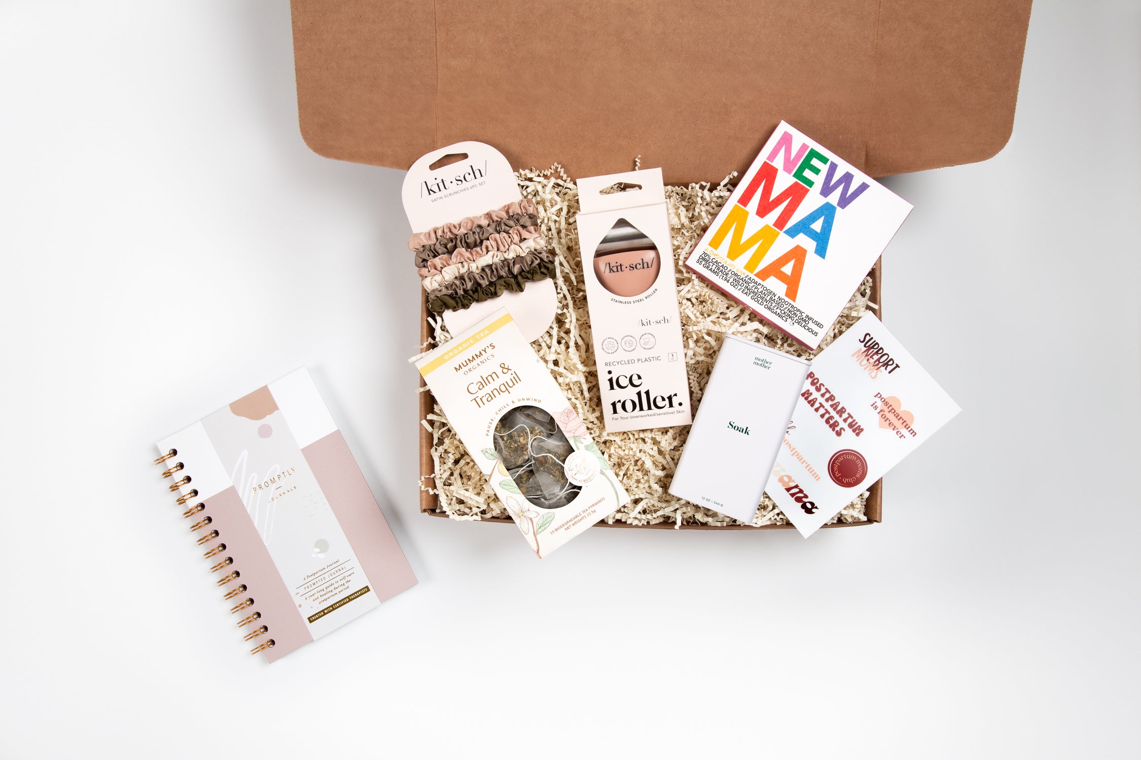 Gift box with various self-care items and a 'NEW MAMA' greeting card.