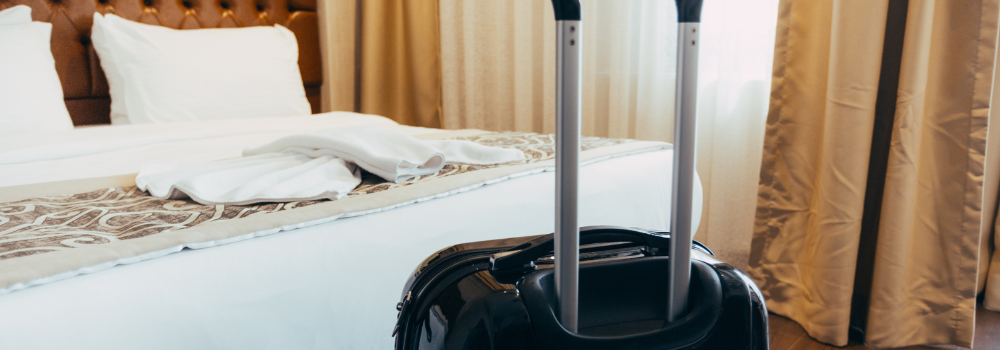 A black suitcase in a hotel room.