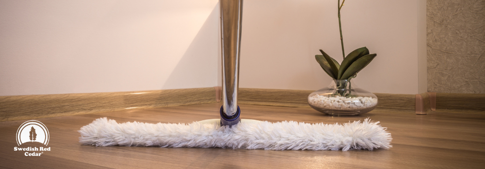 A white mop on wooden floor.