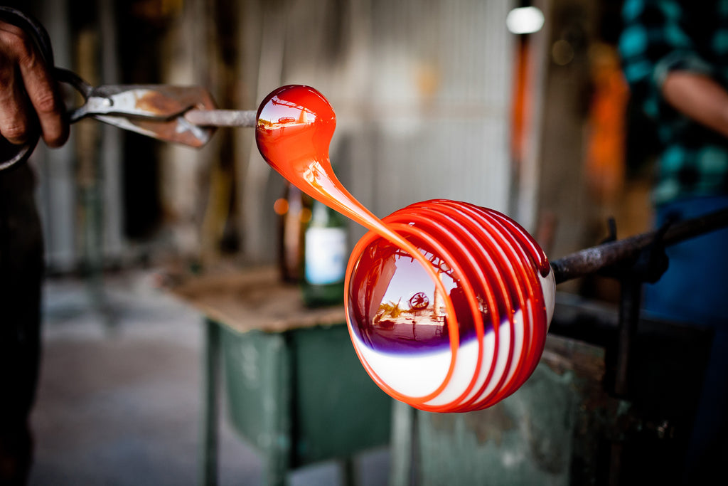 Artisan forming a gather for glassblowing