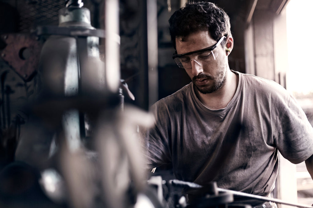 Metal worker amid equipment