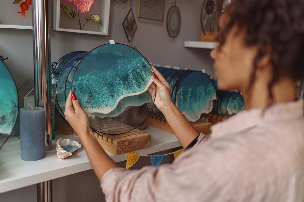 woman examining kiln formed glass plate