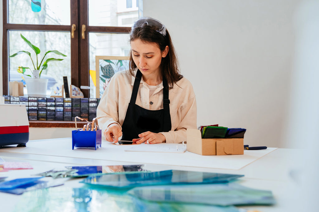 woman working with glass in home studio