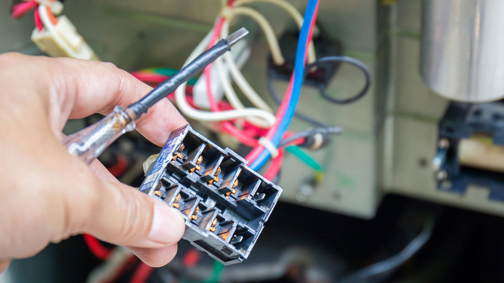 hand holding wiring box for kiln controller