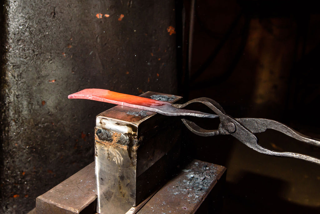 Tongs holding heat treated blade