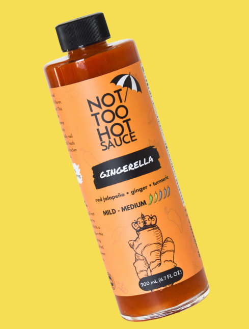 Gingerella Hot Sauce on Yellow Background