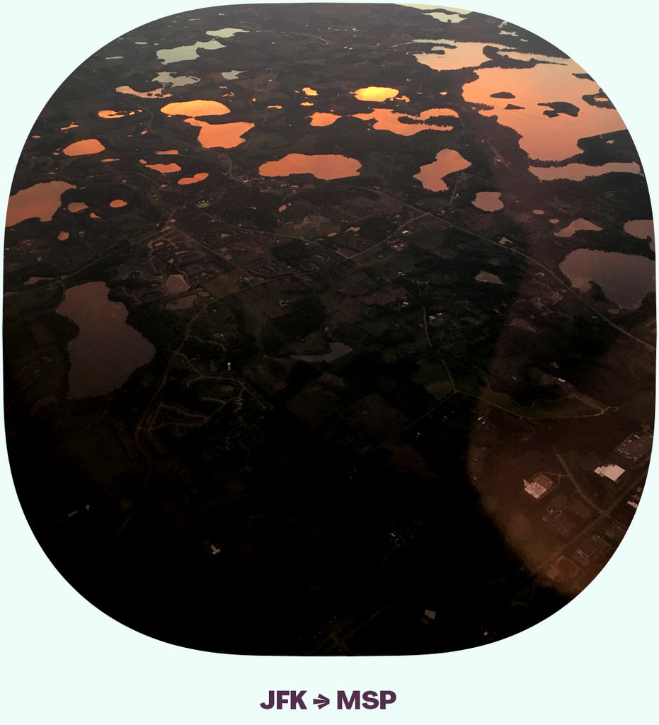 Many lakes, seen from above, with the reflection of a sunset