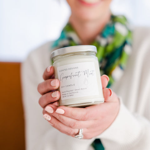 woman holding Grapefruit Mint candle 