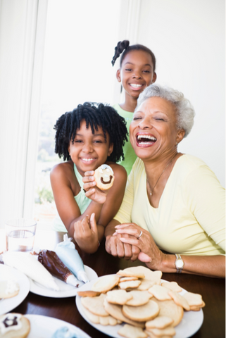 Girls baking cookies with grandma 