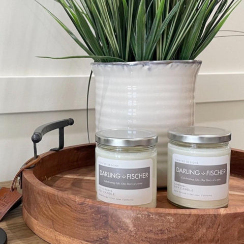 custom branded candles for realtors on a wooden tray with a plant