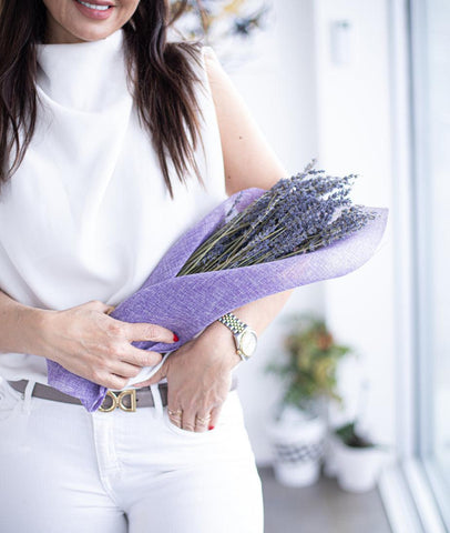 woman holding bundle of lavender