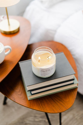 Soy Candle on stack of books in the bedroom