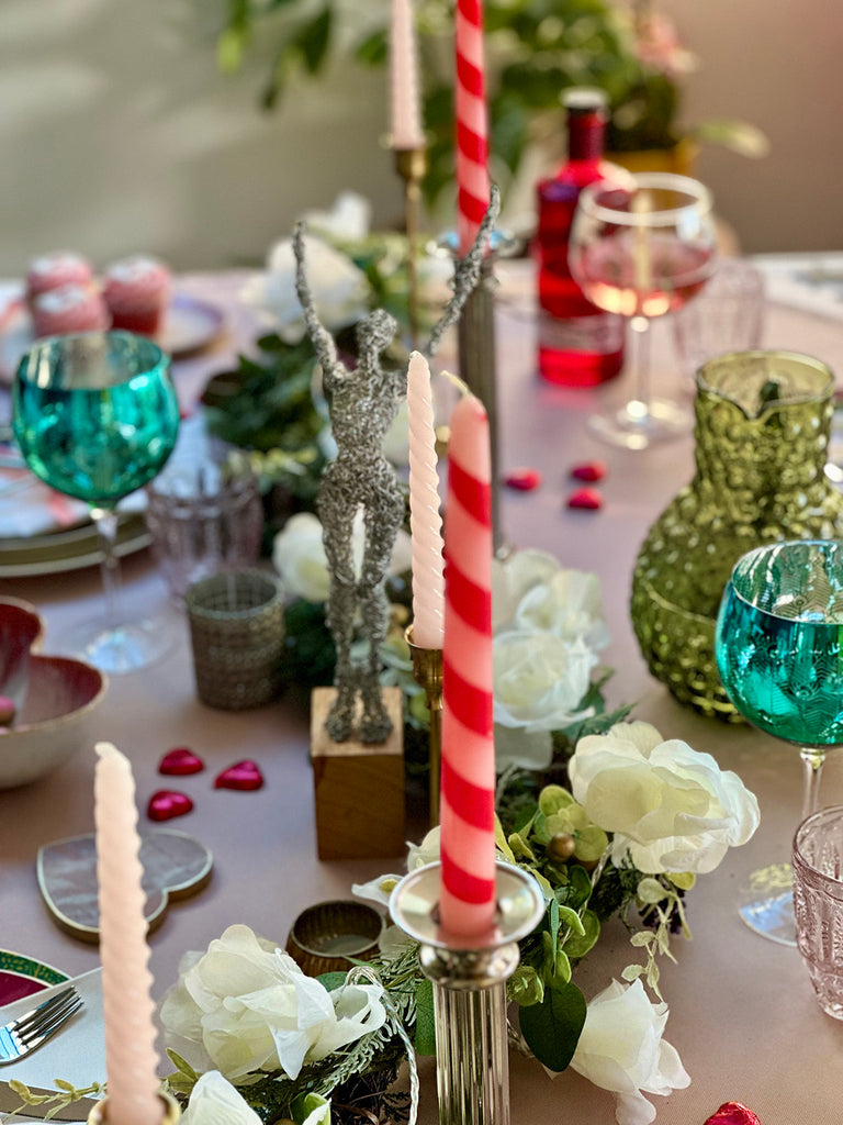 A bunch of candles fill this tablescape designed for The Fine Cotton Company