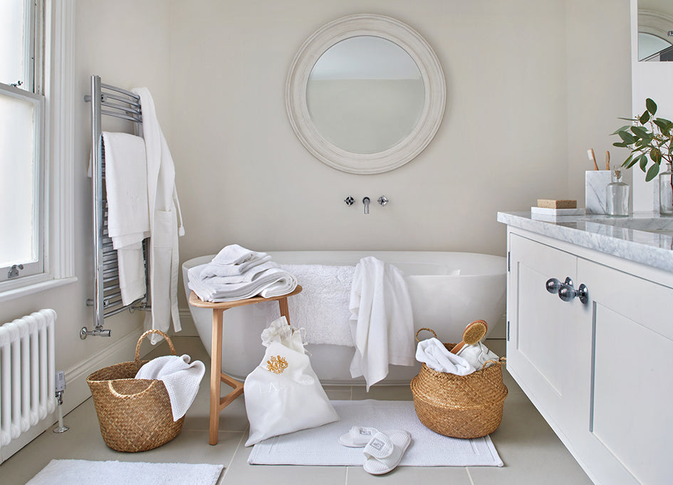 Bathroom with towels, bath mat, laundry bag and bathrobe from The Fine Cotton Company