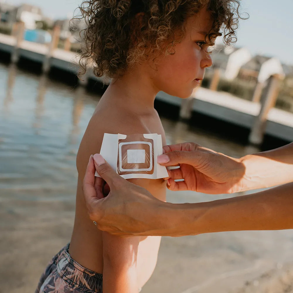 applying a DrySee bandage at the beach