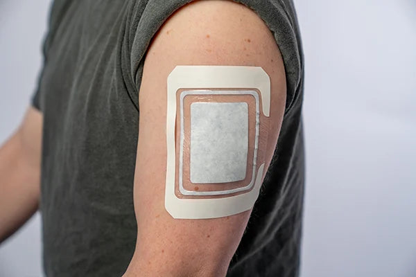 DrySee bandage on a man's upper arm