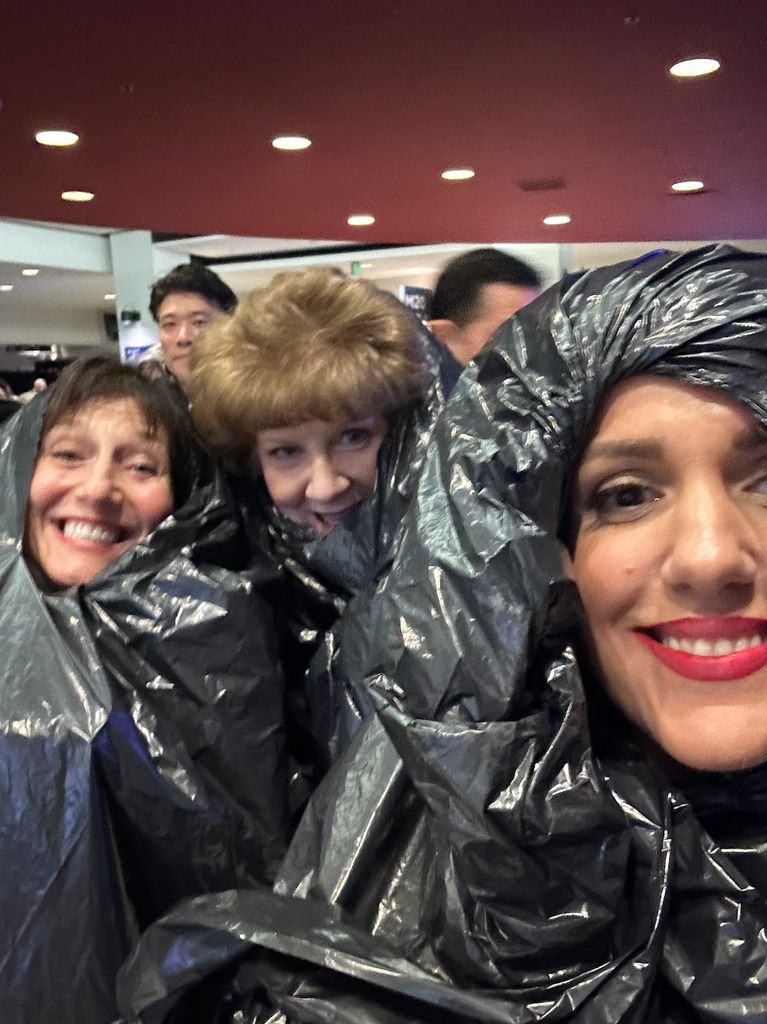 Erin and her mother wearing trash bags over their gowns to escape the rain at the 2024 Grammys