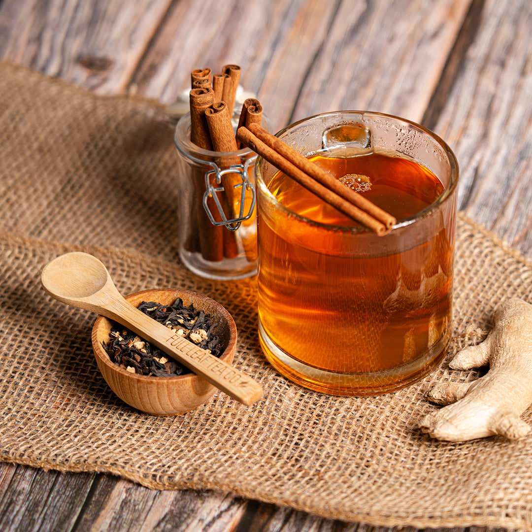 Skinny Natural in a glass cup with cinnamon and skinny natural tea in a wooden bowl
