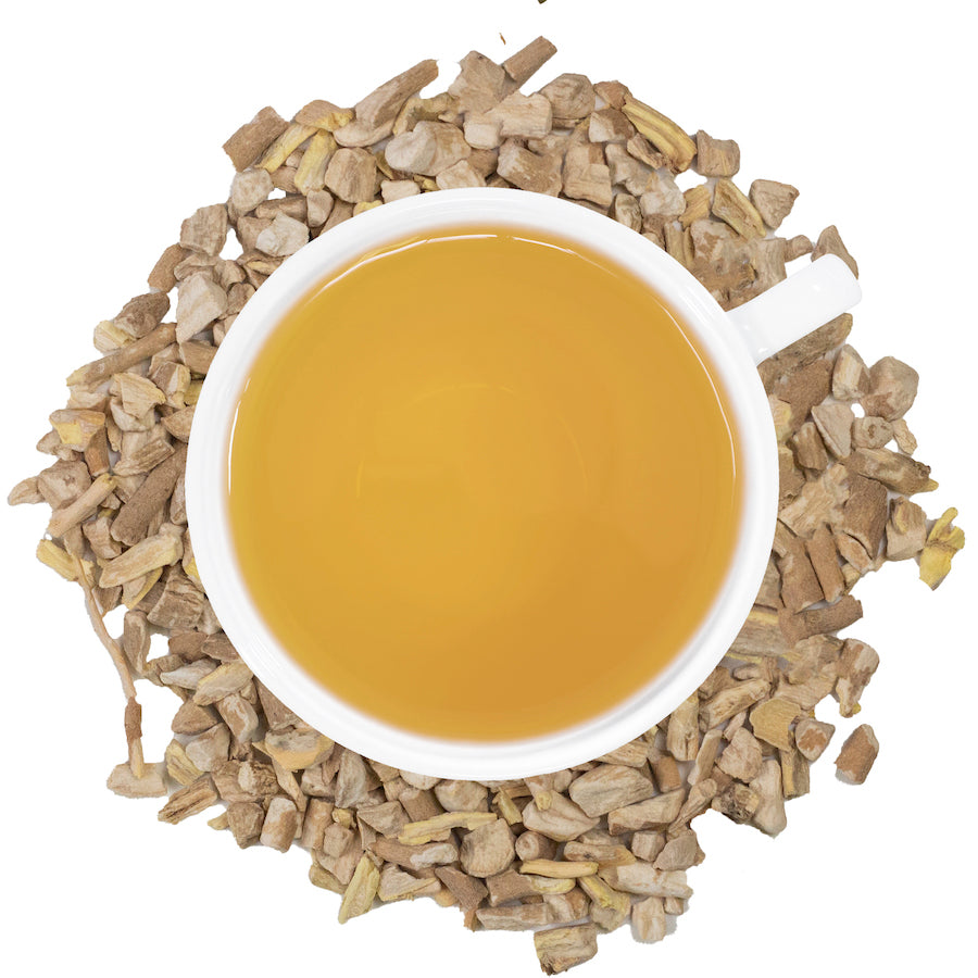 ashwagandha tea in a cup surrounded by dried ashawagonda 