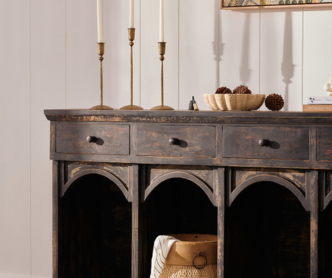 Black wooden console table with decor trinkets styled ontop