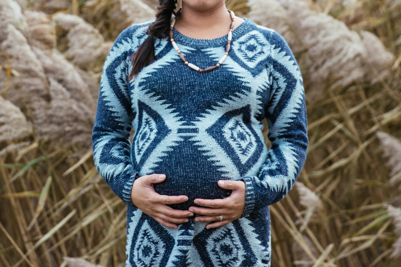 Pregnant woman standing in field