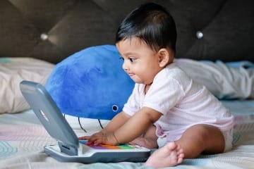 happy baby playing with toy