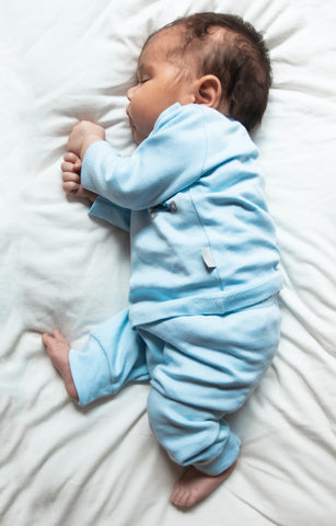 sleeping baby in blue pajamas