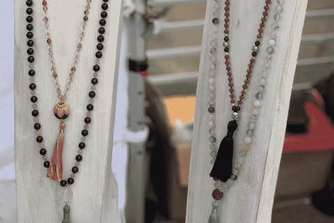 Close up of Seeds of Wonder handmade malas on jewellery stands