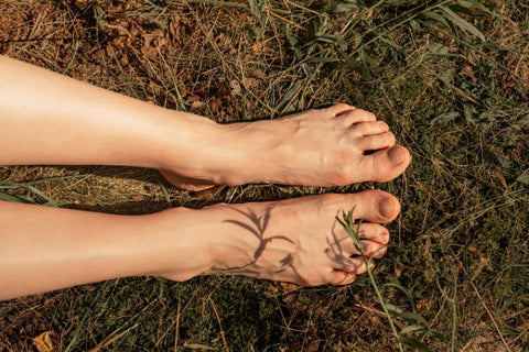 Woman grounding by placing feet on earth