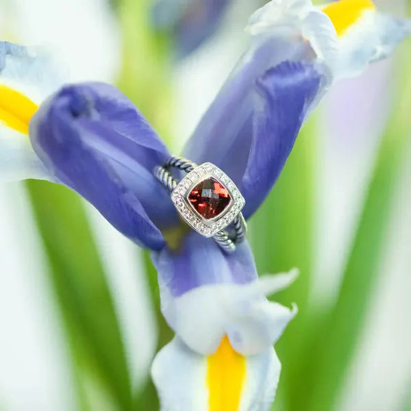 Red gemstone ring on flowers