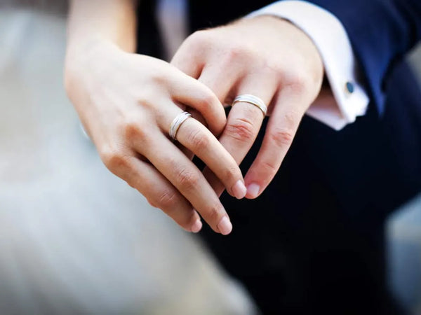 wedding bands on man and woman hands