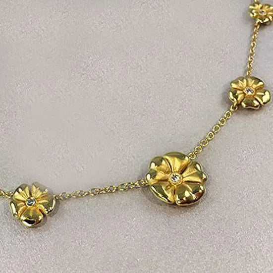 Gold flower pendant by Suna