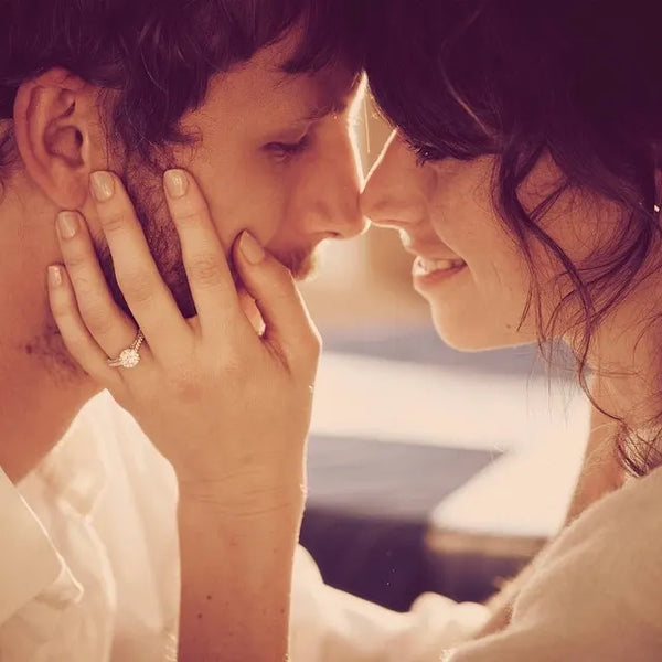 Man and woman nose to nose with diamond ring on her finger