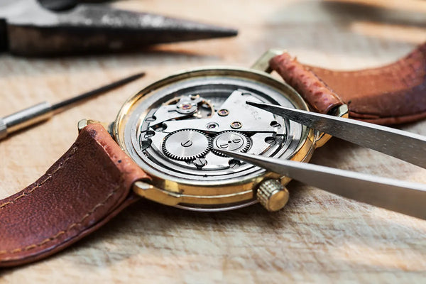 Jeweler working on back of watch