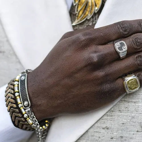 mens hand with two rings and bracelets
