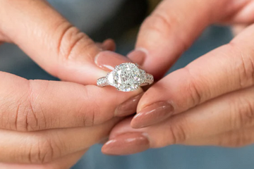 Woman holding a diamond engagement ring