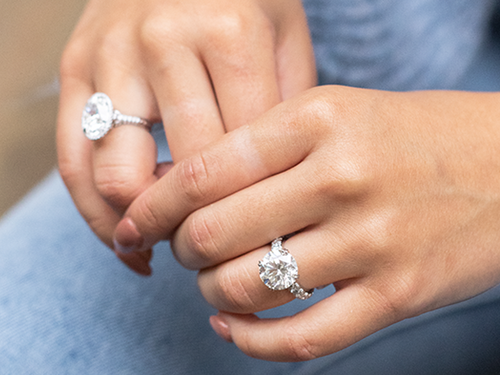 Woman wearing two diamond rings