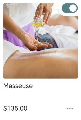 A masseuse pouring oil onto a client's back during a massage session.