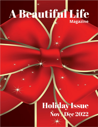 The front cover of A Beautiful Life Magazine Holiday Issue 2022. A Large red ribbon with gold trip covers the entire picture place.