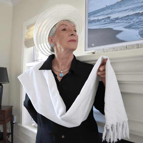 Senior woman wearing a while Turkish towel as an elegant scarf