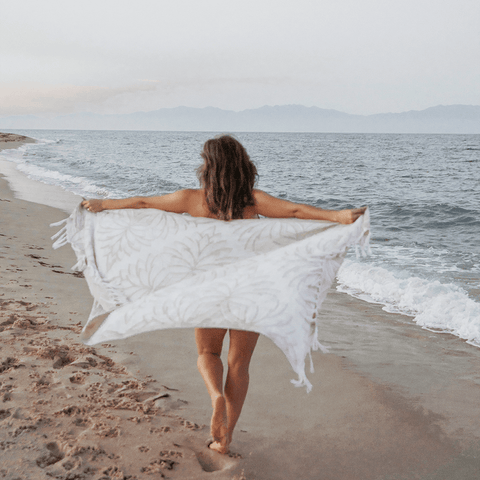 Woman on the beach with a Turkish towel