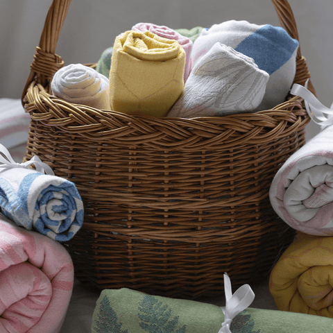 Wicker basket full of Turkish towels wrapped with a bow for gifting