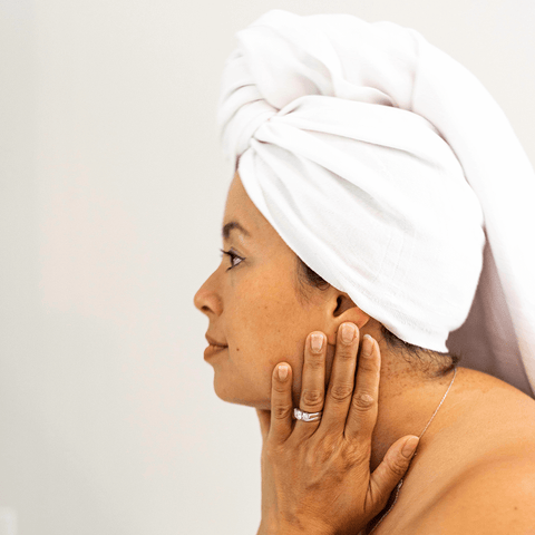 Smiling woman with Turkish towel in her hair after the bath